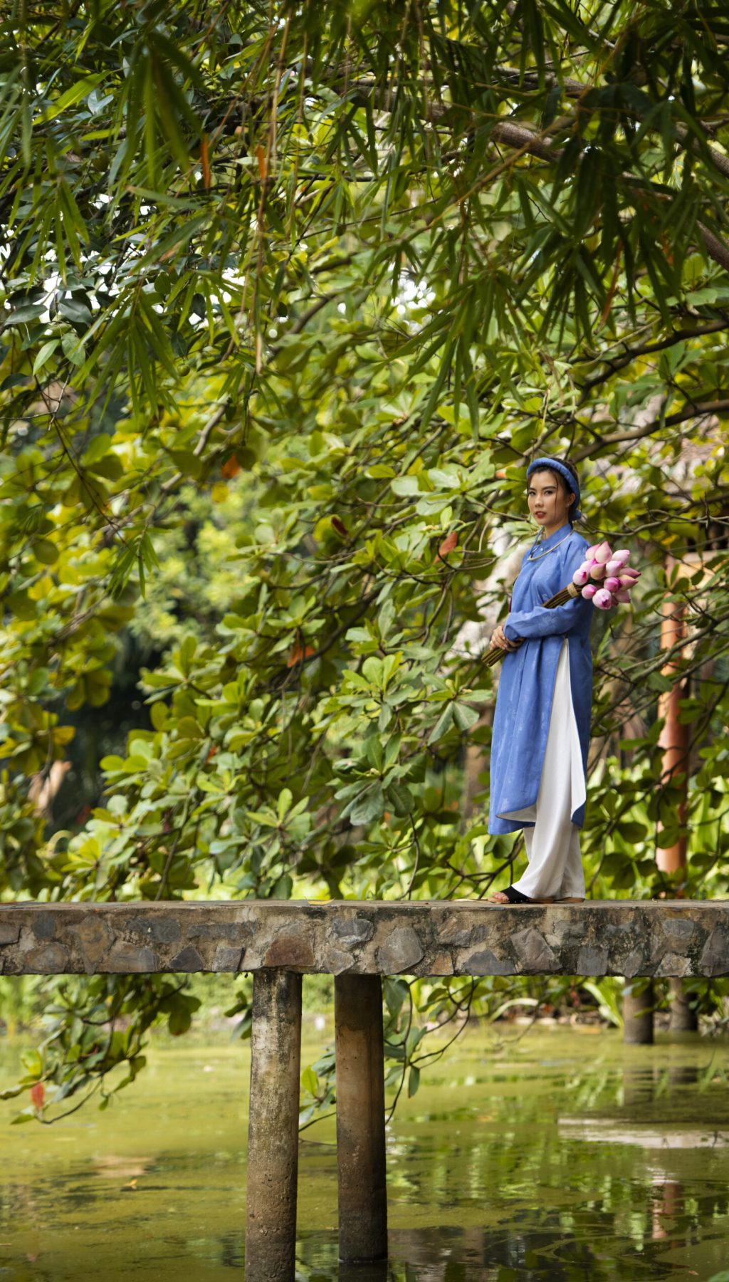 young-woman-with-flower-bouquet-wearing-ao-dai-costume